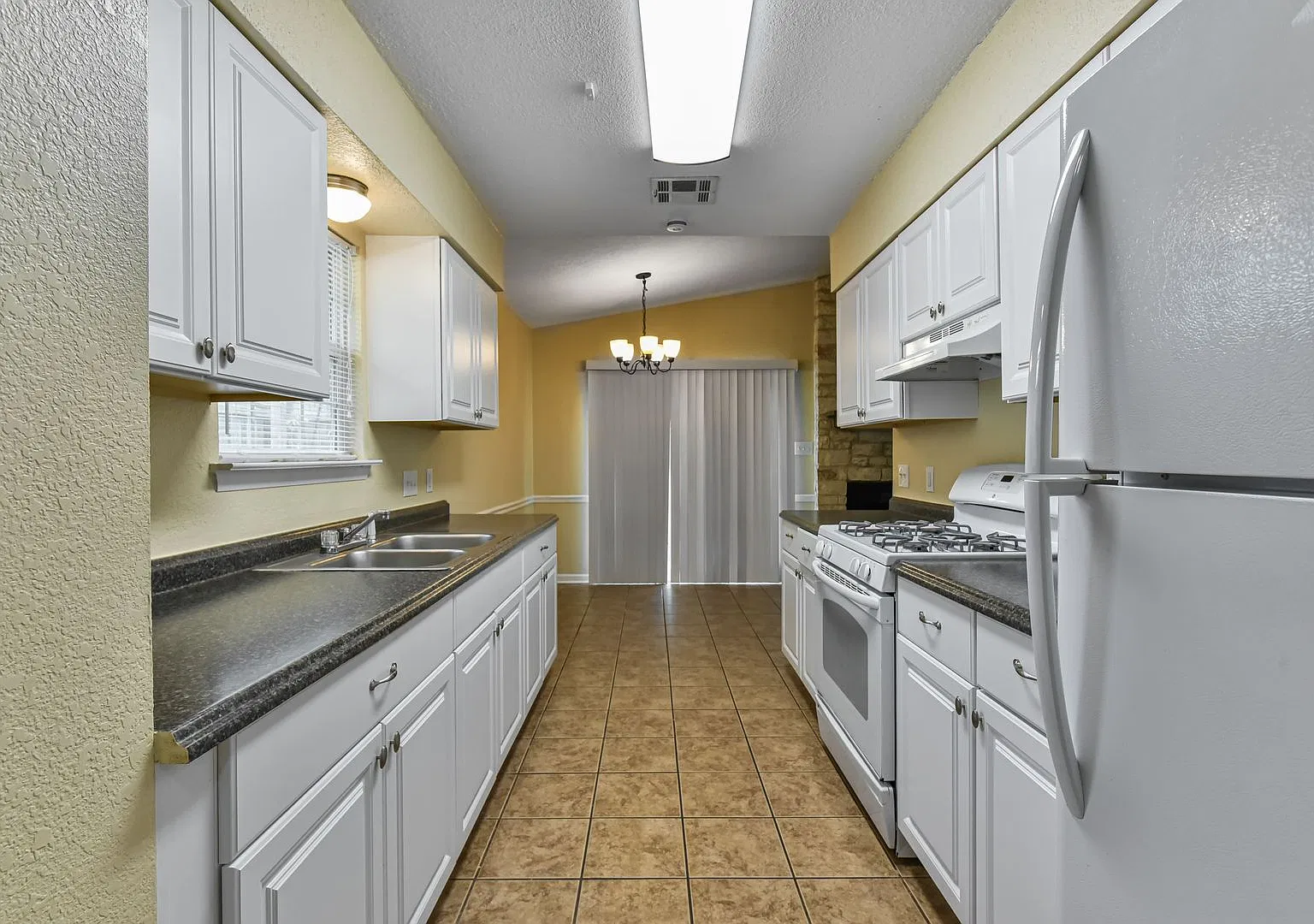 Inviting Townhouse with Cozy Fireplace & Fenced Backyard! — Photo 1