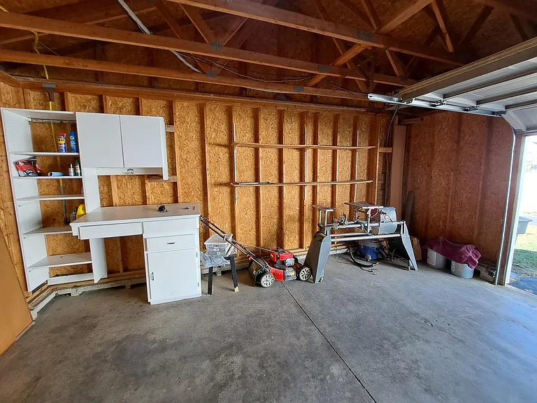 2.5 car garage. Work bench and shelving built-in.