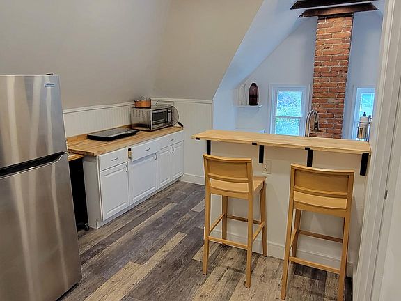 The kitchen has all new appliances, including an induction range top instead of a standard stovetop (with pots/pans) and an extra large air fryer/oven instead of a standard oven. Laundry is on the side, and there is plenty of storage.