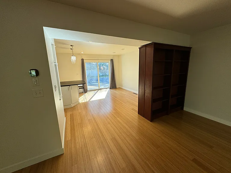 view from living room to the dining room. Large bookcases for storage help provide a cozy nook.