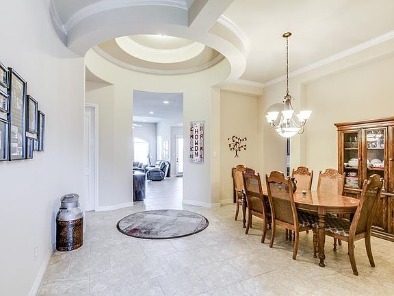 Inside, you are greeted by a dramatic extended entry gracefully surrounded by thoughtful curves leading you to a sneak a peek of the alluring and bright living area, or down another hallway to lead you to the different wings of the home.