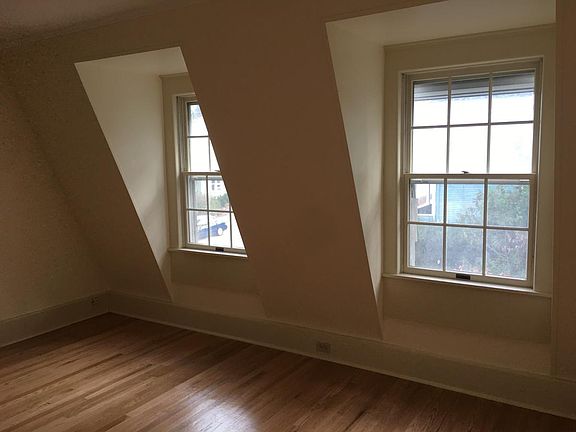 Second bedroom with beautiful windows and more exposed brick
