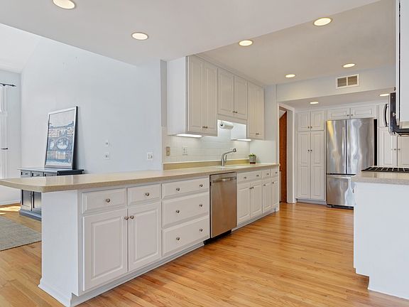 Beautiful kitchen with lots of cabinets, stainless appliance and breakfast bar with seating.