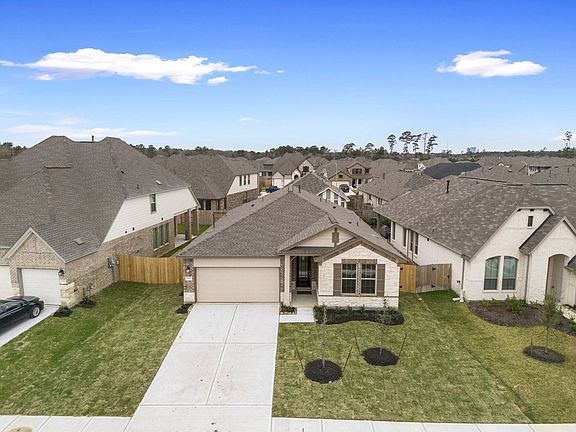Welcome home to 31721 Redbud Blossom Lane located in the community of The Meadows at Imperial Oaks z