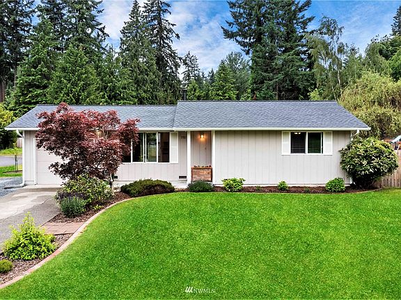 Front of home with sculptured landscaping and wide lawn. The roof is 1 year old!!