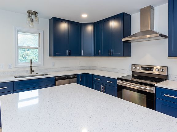 Brand new kitchen with a large island, quartz countertop.