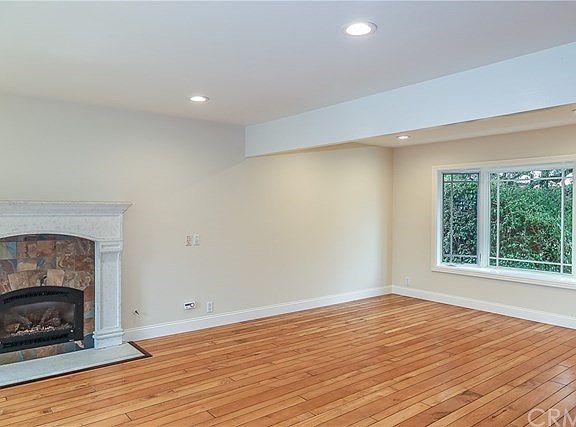 Formal Dining room with window seat looking out to lush landscaping.
