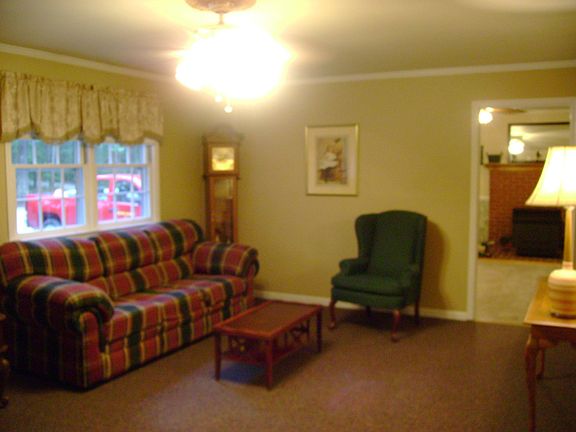 Large Living Room with ceiling fan and crown molding