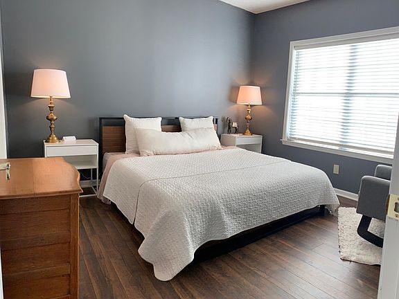 Master bedroom with large custom walk-in closet and large window with sunset views and church steeple views