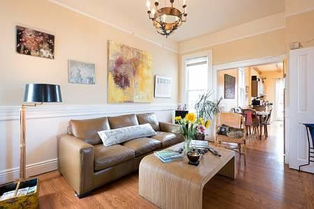 Living room is well decorated with eclectic art and comfortable furniture.