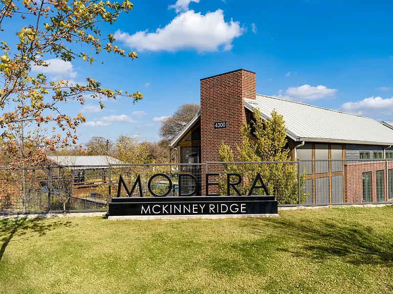 A welcoming first impression at Modera McKinney Ridge, surrounded by open green space and thoughtful community design.
