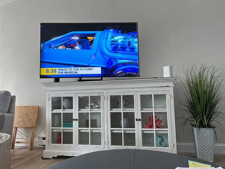 Smart tv over shelving unit.