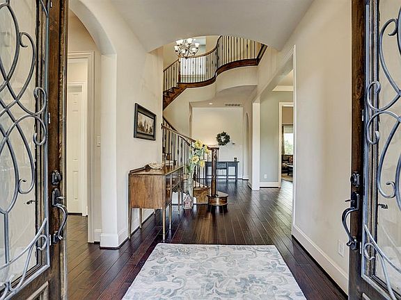 Stunning entryway and spiral staircase welcome you into this Highland built home.