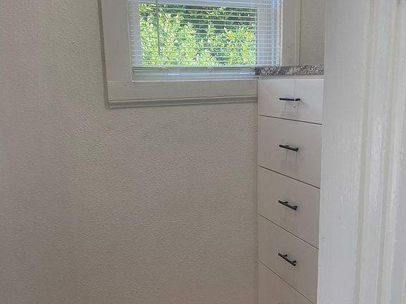 Looking out from bathroom to hallway with dresser