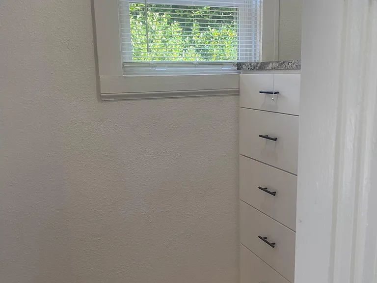 Looking out from bathroom to hallway with dresser