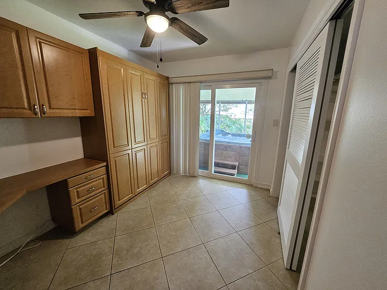 Bedroom #2/Office with built-in desk and murphy bed, access to screened porch