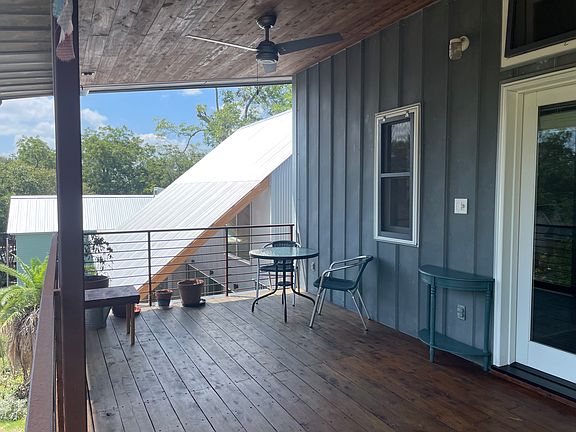 Front house on property visible beyond the balcony railing