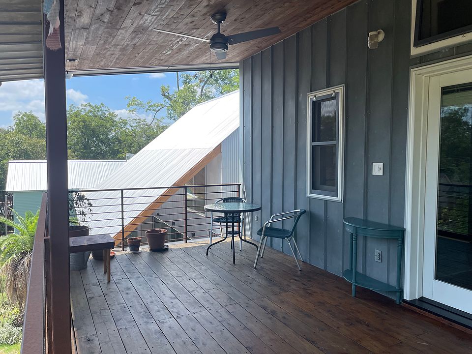 Front house on property visible beyond the balcony railing