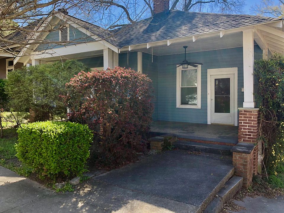 Front of home with lovely shrubs that add privacy