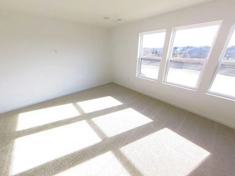 Upstairs bedroom #4 with a beautiful view overlooking the pond and backyard.