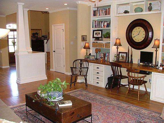 Cozy study with custom built in desk and book shelves with gas log hearth