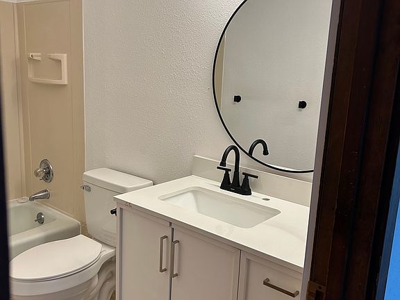 Remodeled bathroom. New flooring, vanity, mirror, lighting, bathroom fan.