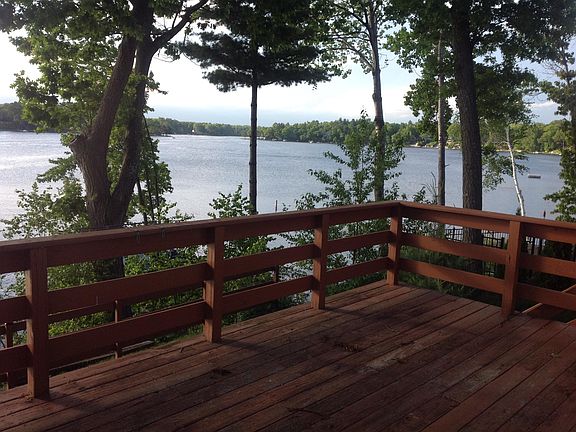 Deck wraps around side and back of home