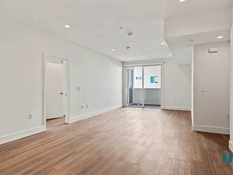 Open-Concept Dining and Living Room with Vinyl Flooring, Recessed Lighting, and Patio