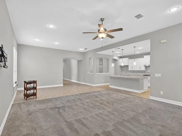 Open concept interior featuring light gray walls and recessed lighting