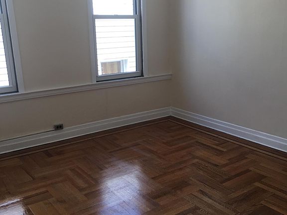 Large living room space, newly renovated with newly finished flooring.