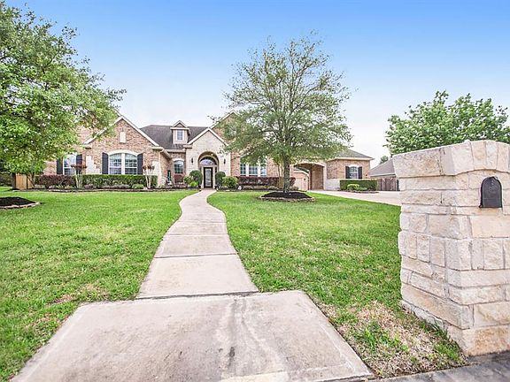 Brick and stone elevation with mature trees and landscaping offers such great curb appeal.