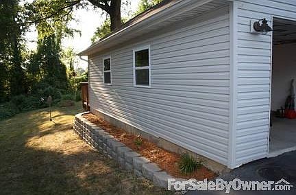 Side of Garage
						:
						Modular block wall with landscaping.