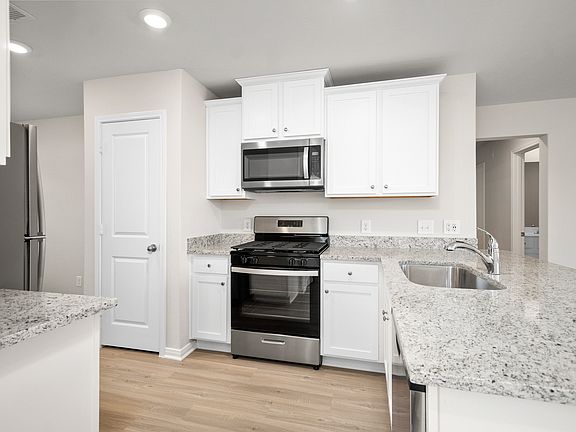 The kitchen is filled with stainless-steel appliances.