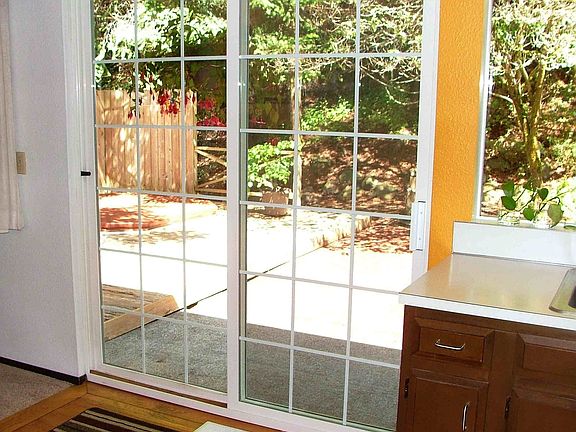 from kitchen to backyard patio and hot tub area