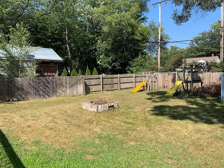 Large backyard with firepit.