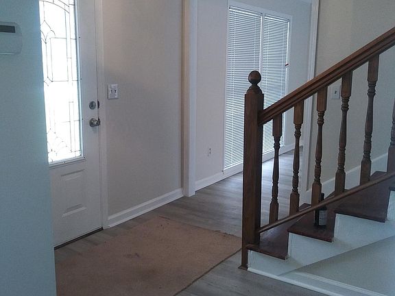 Front door and steps to second floor , living space # 1 to the left , Living space# 2 to the right with non working fireplace .