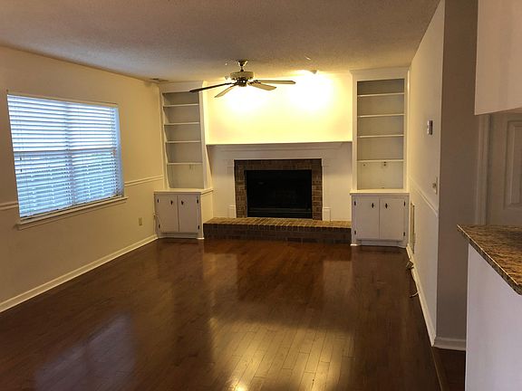 Living room with hardwood floors and wood-burning fireplace