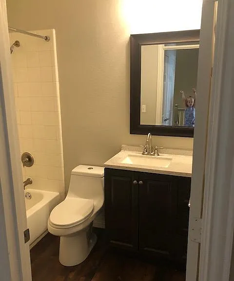Second full bath upstairs displays a custom cabinet/sink.