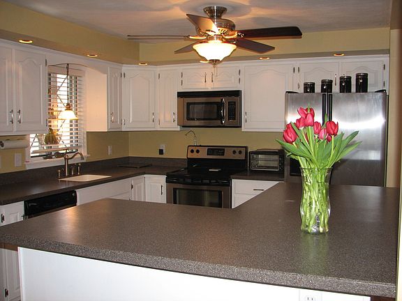 Corian counters and a breakfast bar complete this kicthen perfectly
