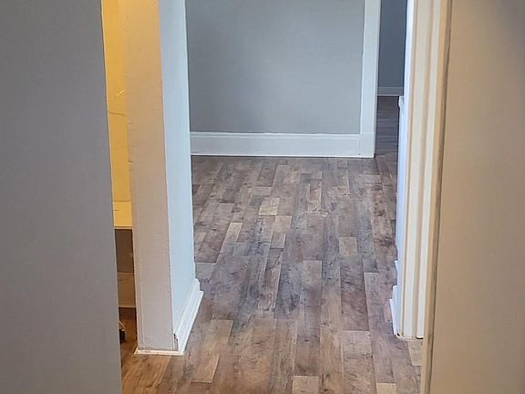 Hallway from living room to the rest of the apartment. Left door is to the basement, right door is the spare bedroom.