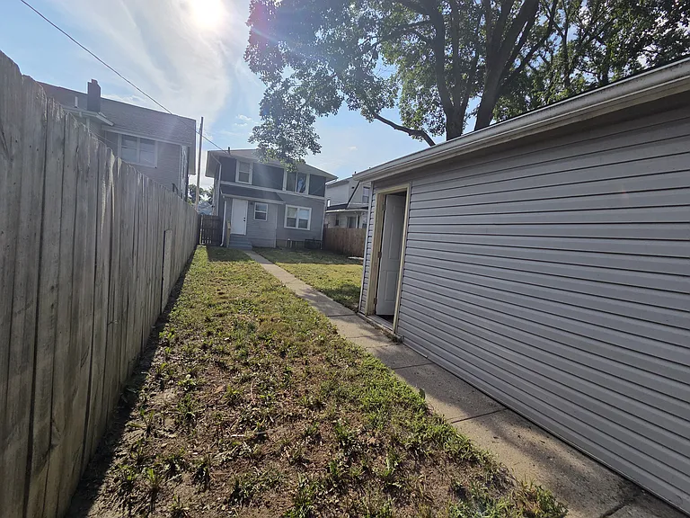 Fenced backyard and garage side door