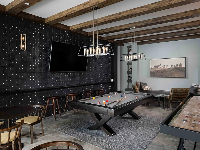 Entertainment lounge with pool table, games, and TVs