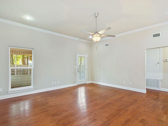 Hardware living room floors, high ceilings and door to side screened patio