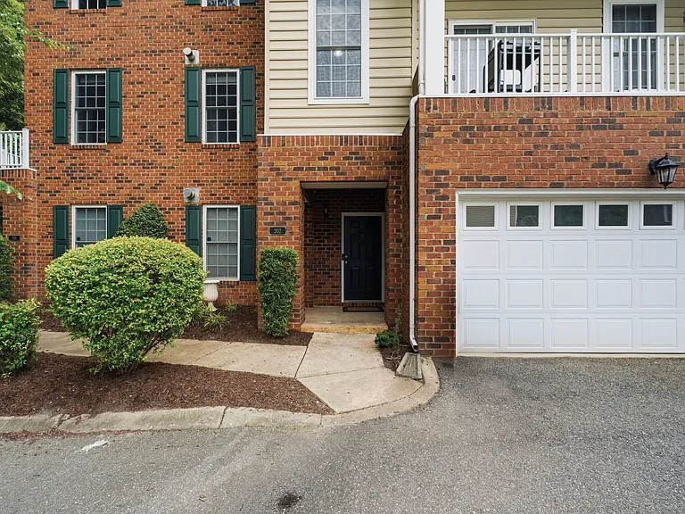 Front porch, garden, sidewalk, garage and parking area