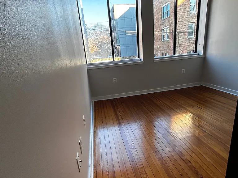 Back sunroom or living room adjacent to kitchen/dining area.