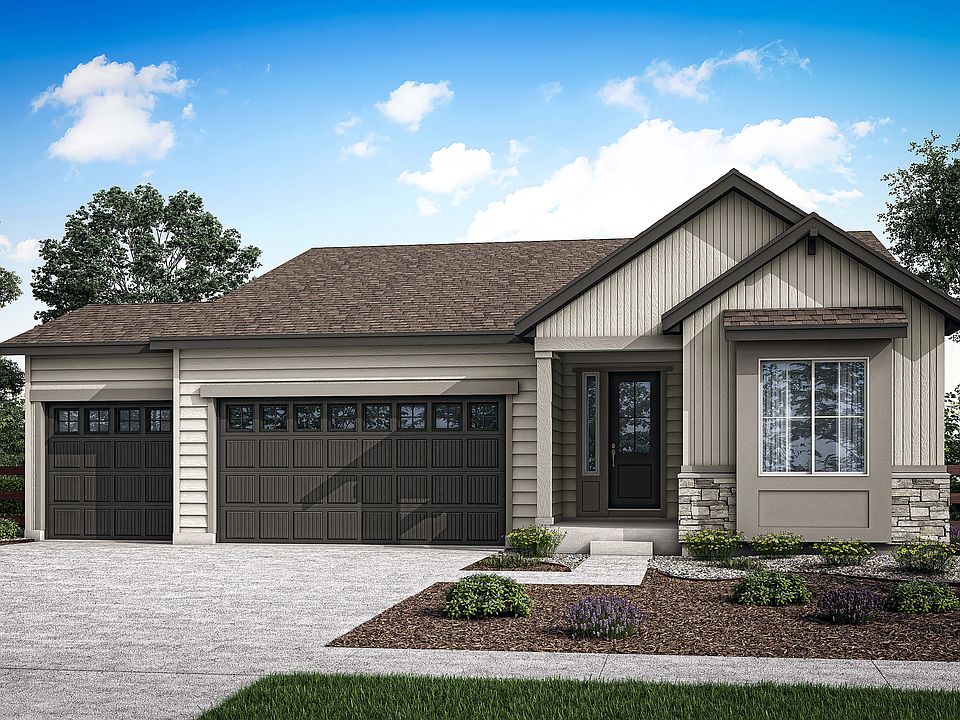 A well-designed, two-story residential home with a garage, surrounded by lush greenery and a clear b