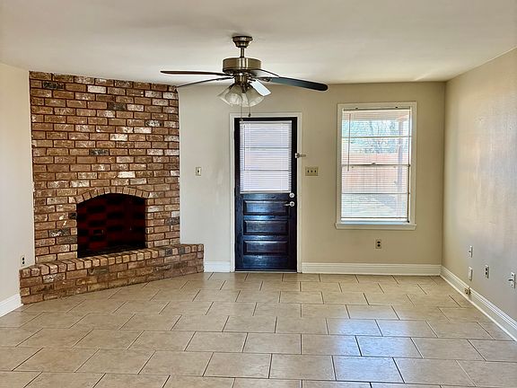 living roon with cozy fireplace with rear yard access