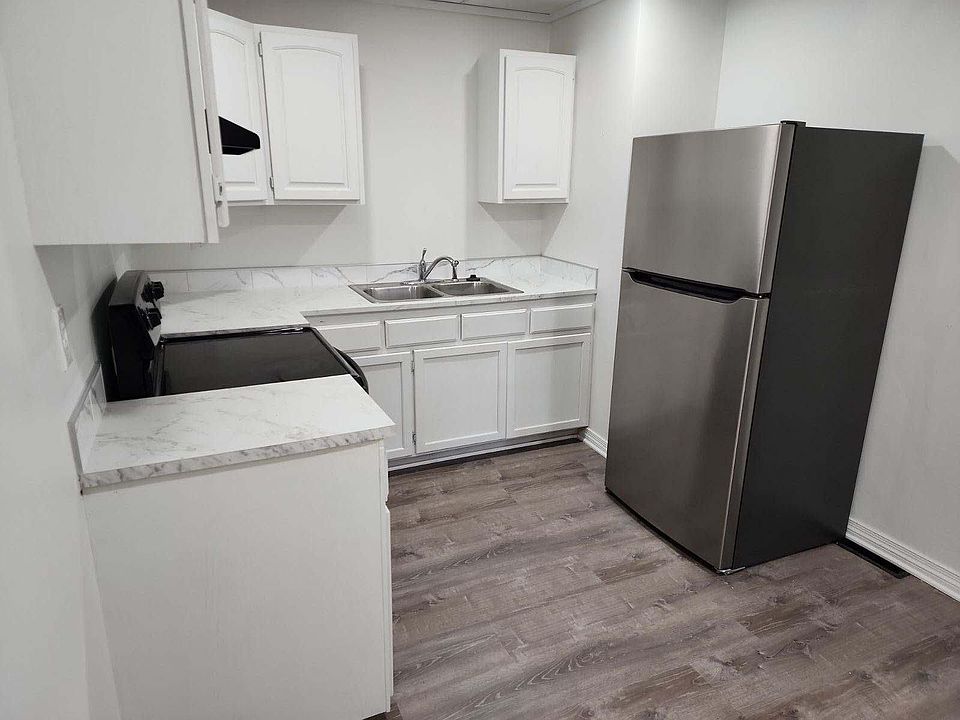 Kitchen has new paint, counter tops, and flooring