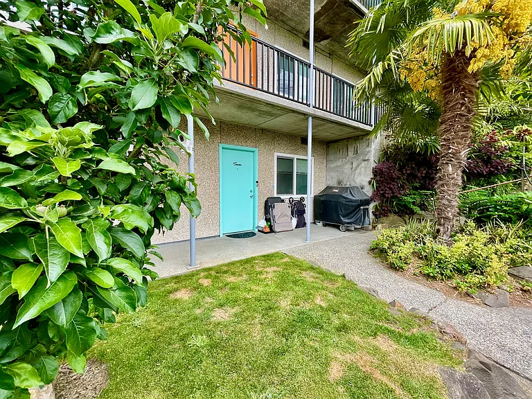 Apt 7 exterior with small space for BBQ, seating, or garden pots.