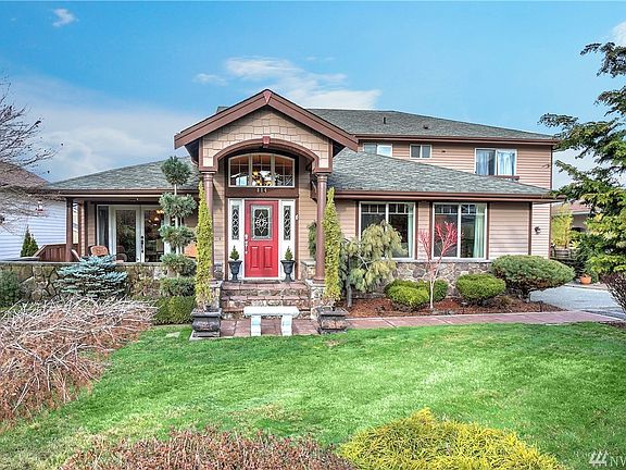 Enjoy your own private front yard oasis created from carefully designed landscaping with bursts of color and texture throughout 